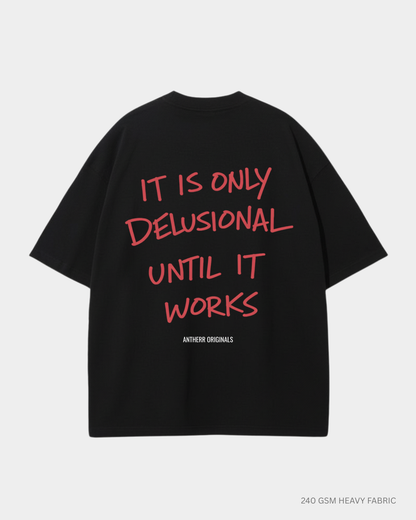 black oversized t shirt with it is only delusional until it works quote
