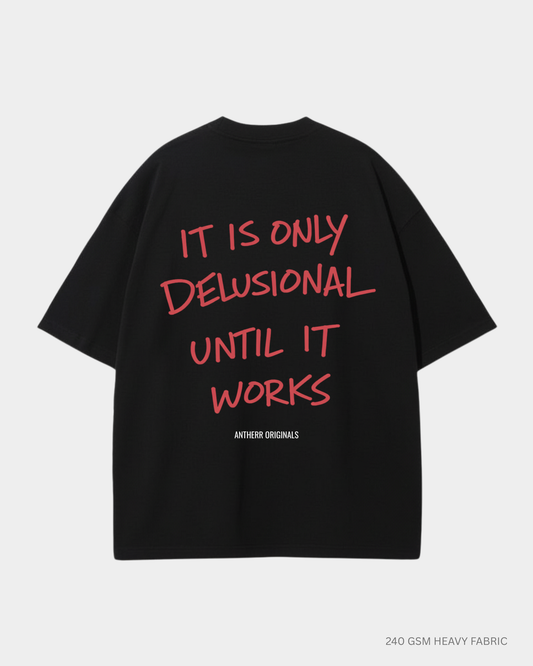black oversized t shirt with it is only delusional until it works quote
