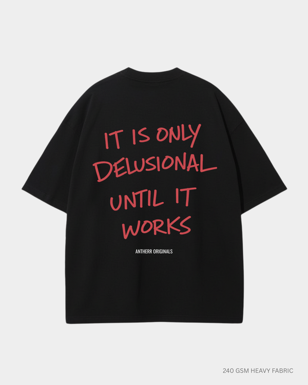 black oversized t shirt with it is only delusional until it works quote