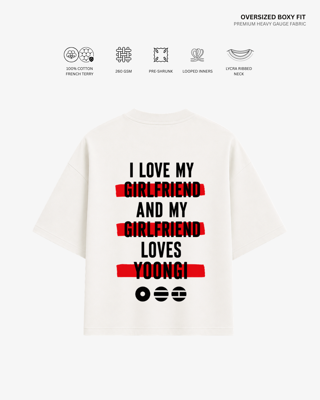 A white oversized boxy-fit T-shirt shown from the back, featuring a humorous printed slogan in black text with red highlight bars and black emoji faces. The image includes feature icons and text at the top detailing the fabric's properties.