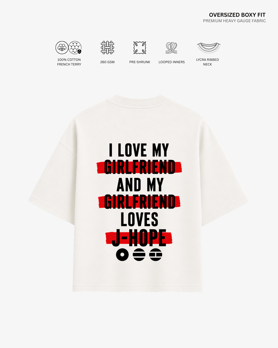A white oversized boxy-fit T-shirt shown from the back, featuring a bold graphic print in black and red text that reads 'I LOVE MY GIRLFRIEND AND MY GIRLFRIEND LOVES I-HOPE' with red scribble-style bars under key phrases. Small fabric feature icons and text appear above the shirt on a light gray background.